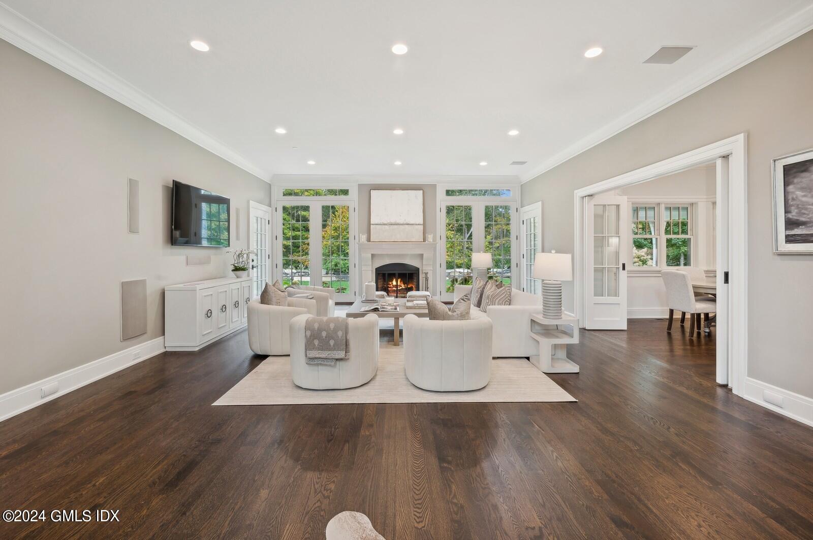 155 Cat Rock Road Cos Cob, CT 06807 - Photo 3 of 29 a living room with furniture a flat screen tv and wooden floor