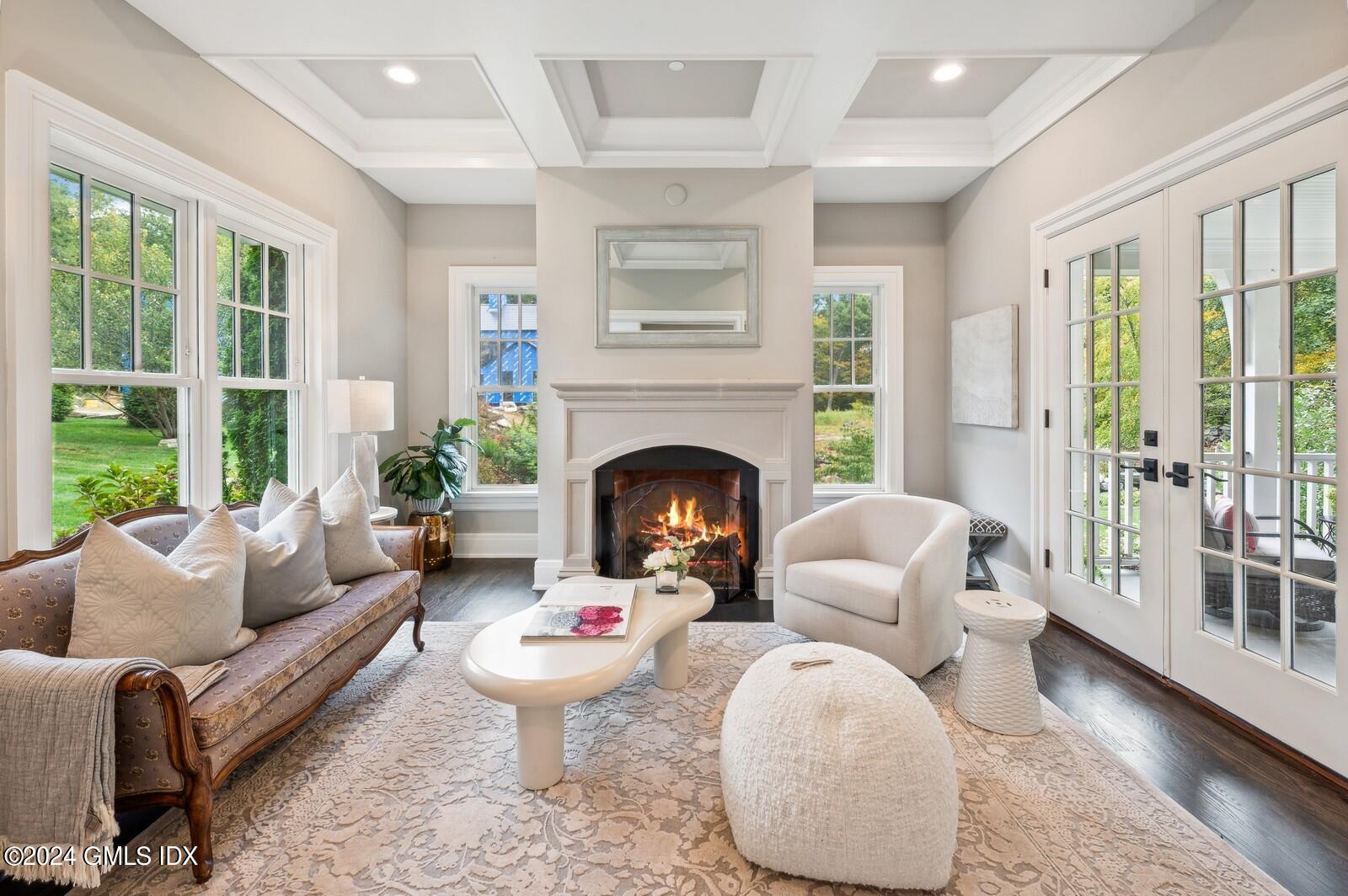 155 Cat Rock Road Cos Cob, CT 06807 - Photo 5 of 29 a living room with furniture a large window and a fireplace