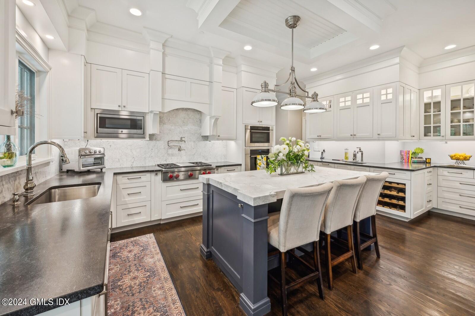 155 Cat Rock Road Cos Cob, CT 06807 - Photo 7 of 29 a kitchen with stainless steel appliances granite countertop a kitchen island hardwood floor sink and stove