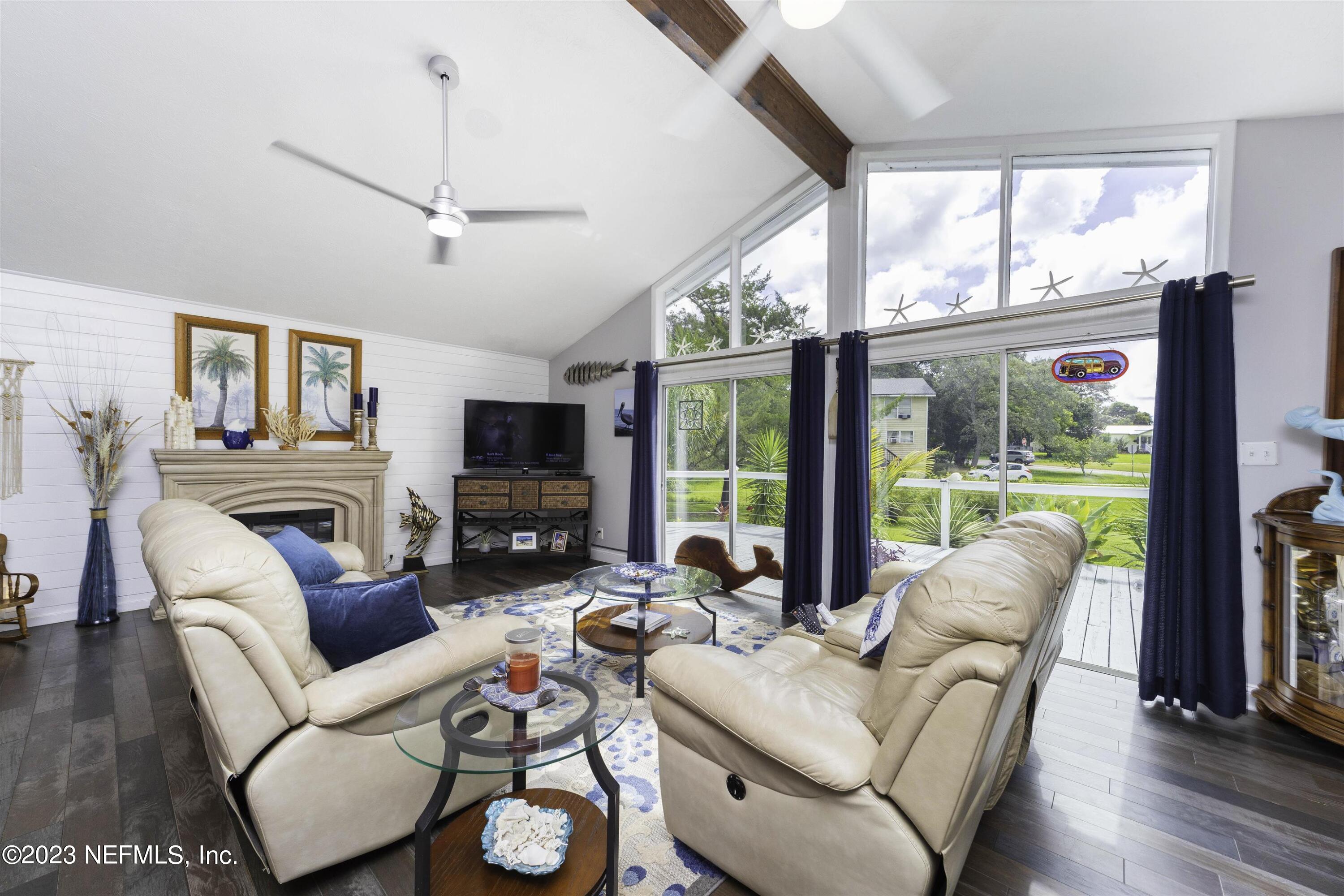 111 Loyola Road St. Augustine, FL 32086 - Photo 12 of 67 a living room with furniture a flat screen tv and a large window