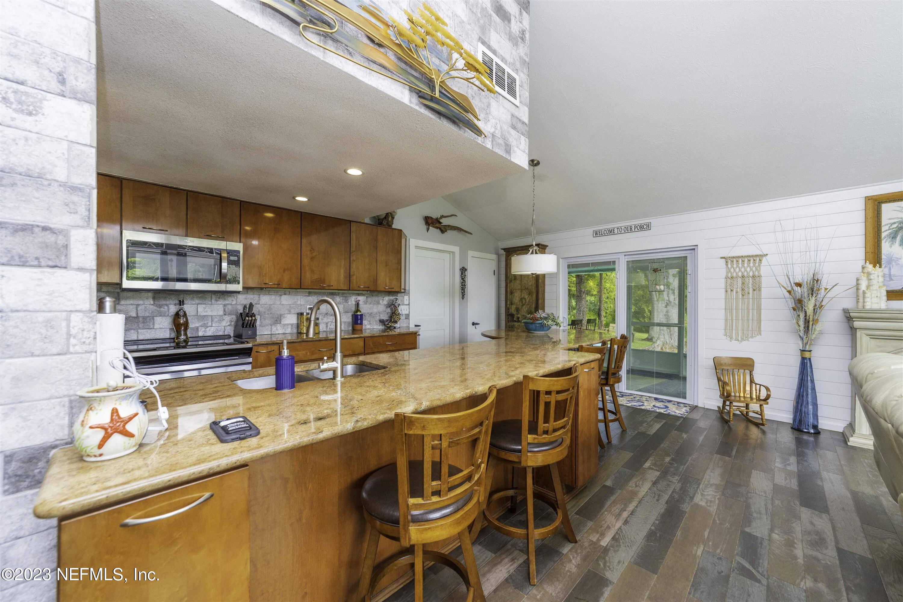 111 Loyola Road St. Augustine, FL 32086 - Photo 15 of 67 a kitchen with stainless steel appliances granite countertop a stove a sink a refrigerator and island