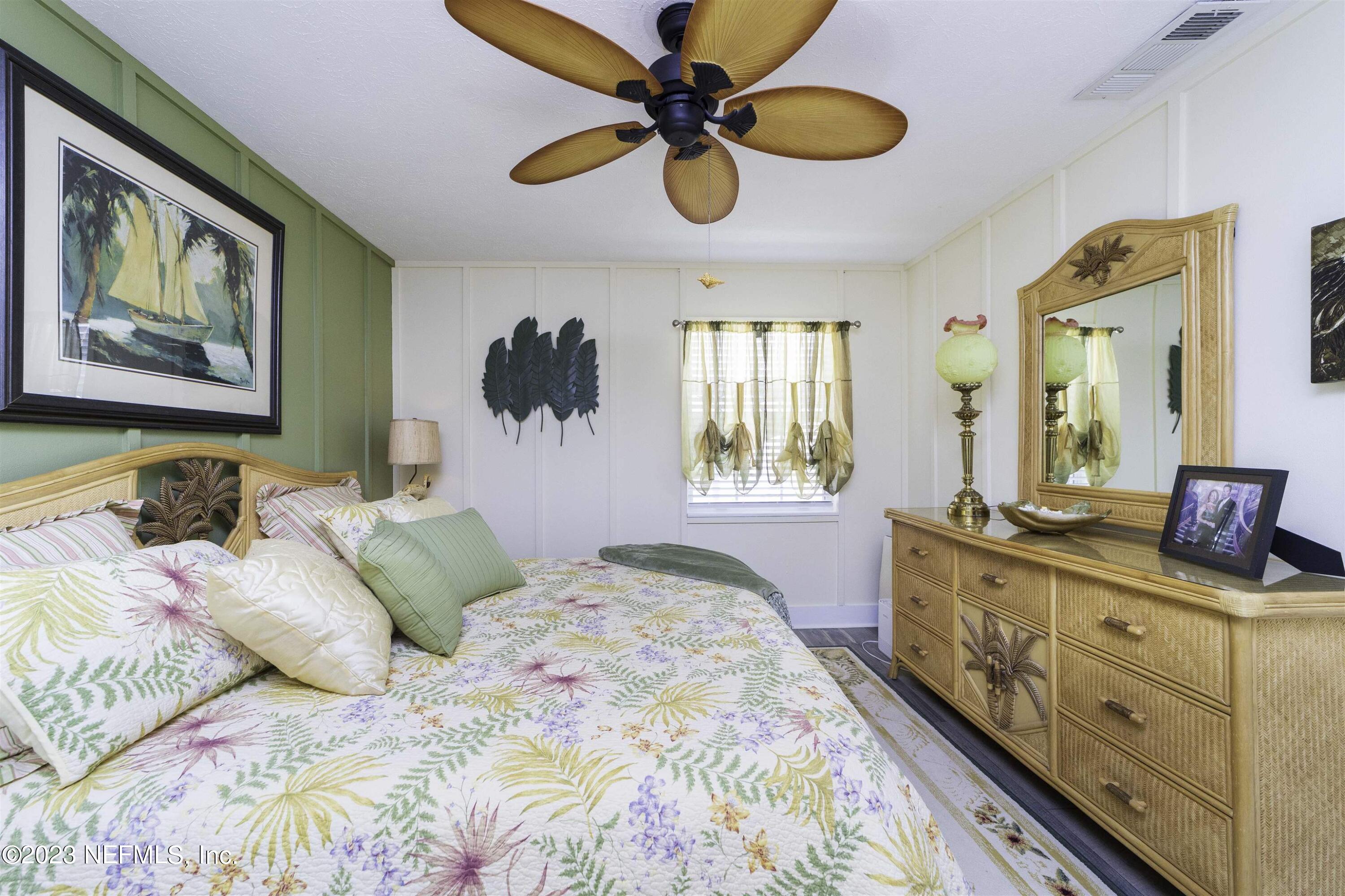 111 Loyola Road St. Augustine, FL 32086 - Photo 25 of 67 a bedroom with a bed and a painting on the wall