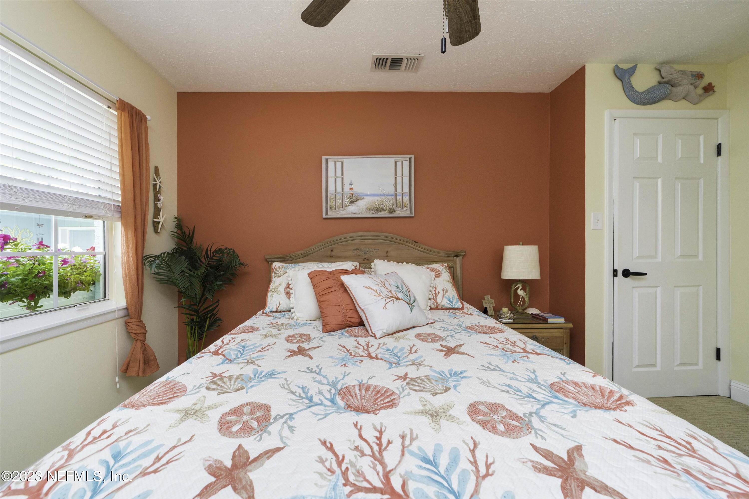 111 Loyola Road St. Augustine, FL 32086 - Photo 31 of 67 a bedroom with a bed and a potted plant