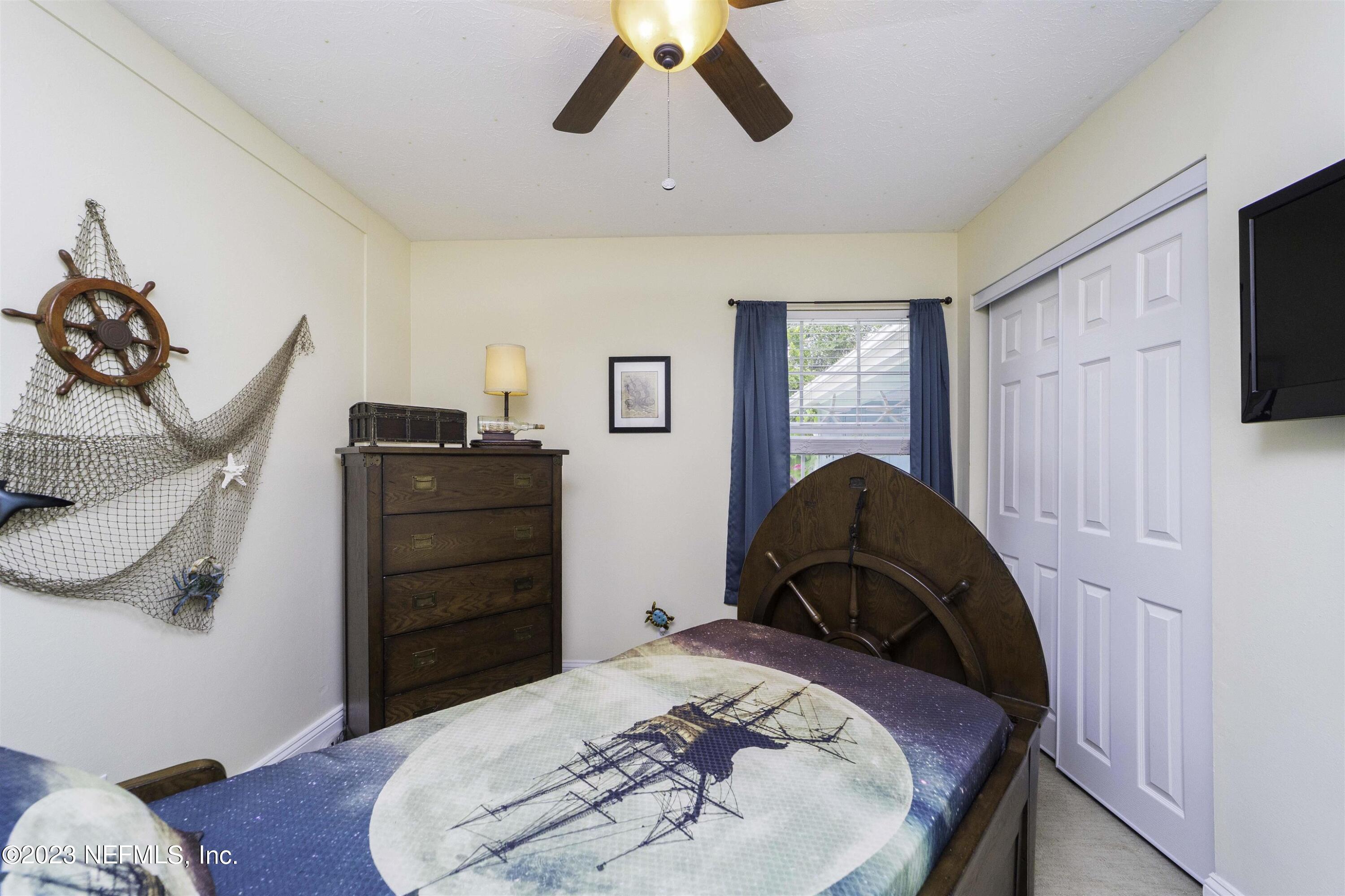 111 Loyola Road St. Augustine, FL 32086 - Photo 33 of 67 a bedroom with a bed and a flat tv screen on dresser