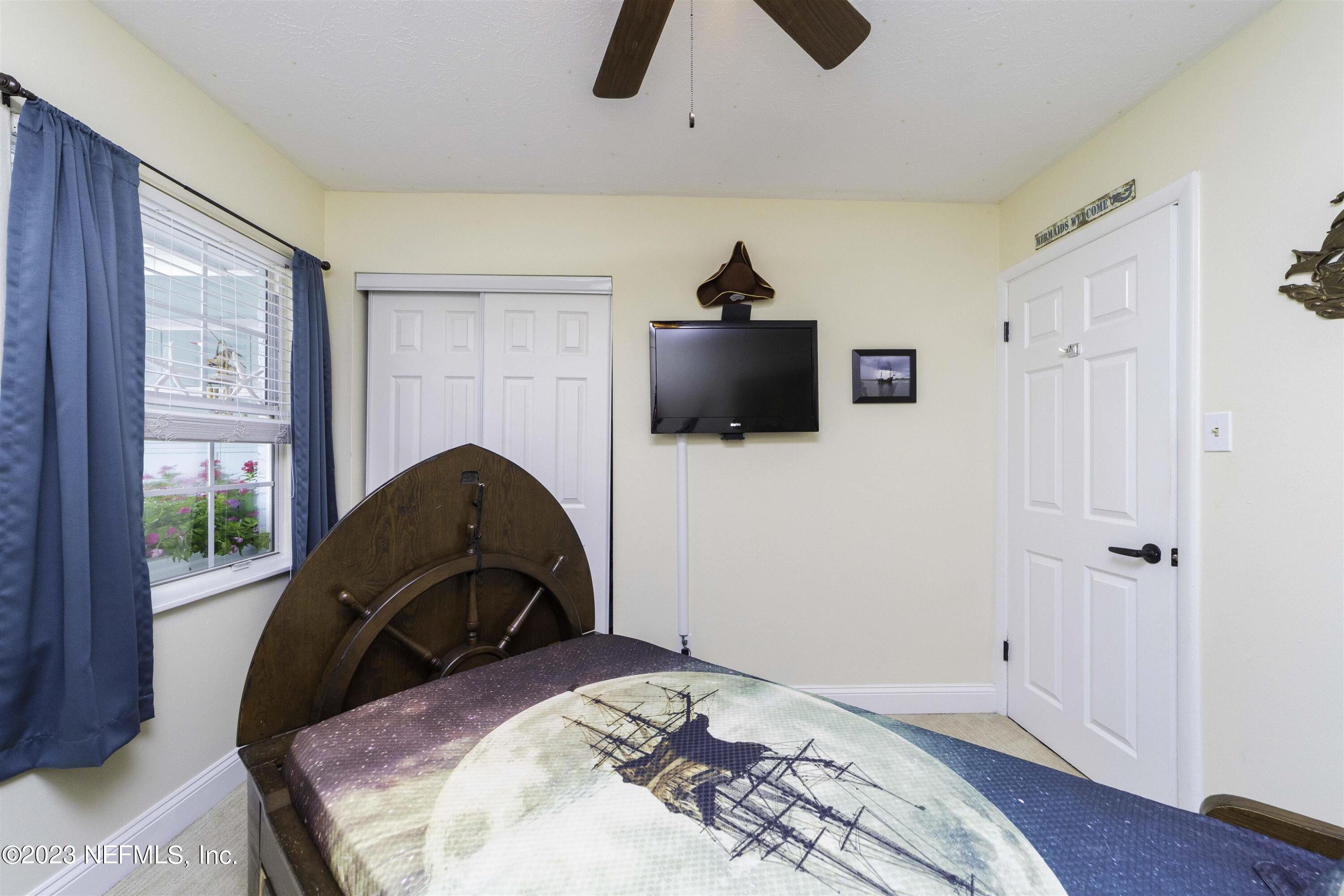 111 Loyola Road St. Augustine, FL 32086 - Photo 35 of 67 a bedroom with a bed and a television