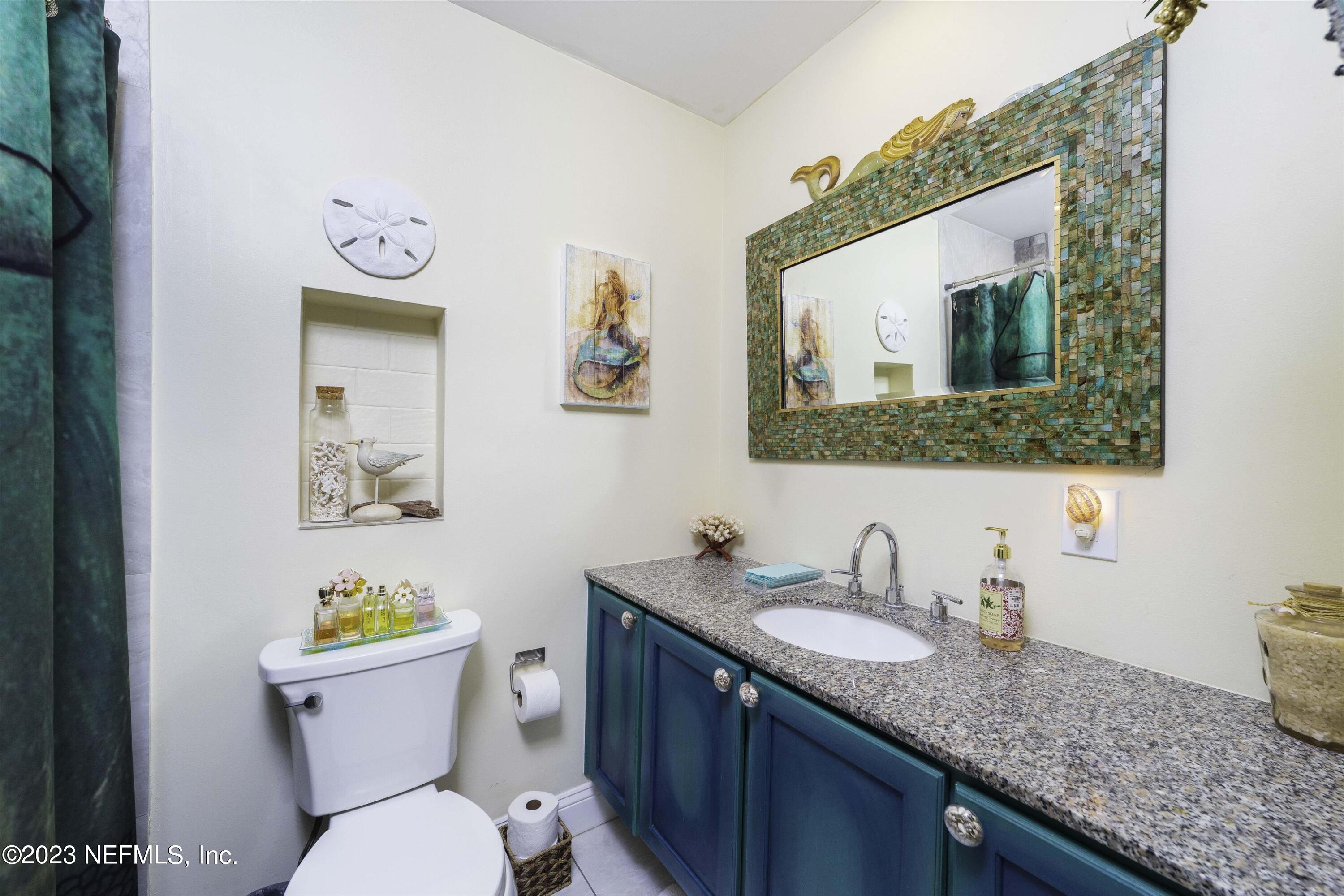 111 Loyola Road St. Augustine, FL 32086 - Photo 36 of 67 a bathroom with a granite countertop toilet sink and mirror