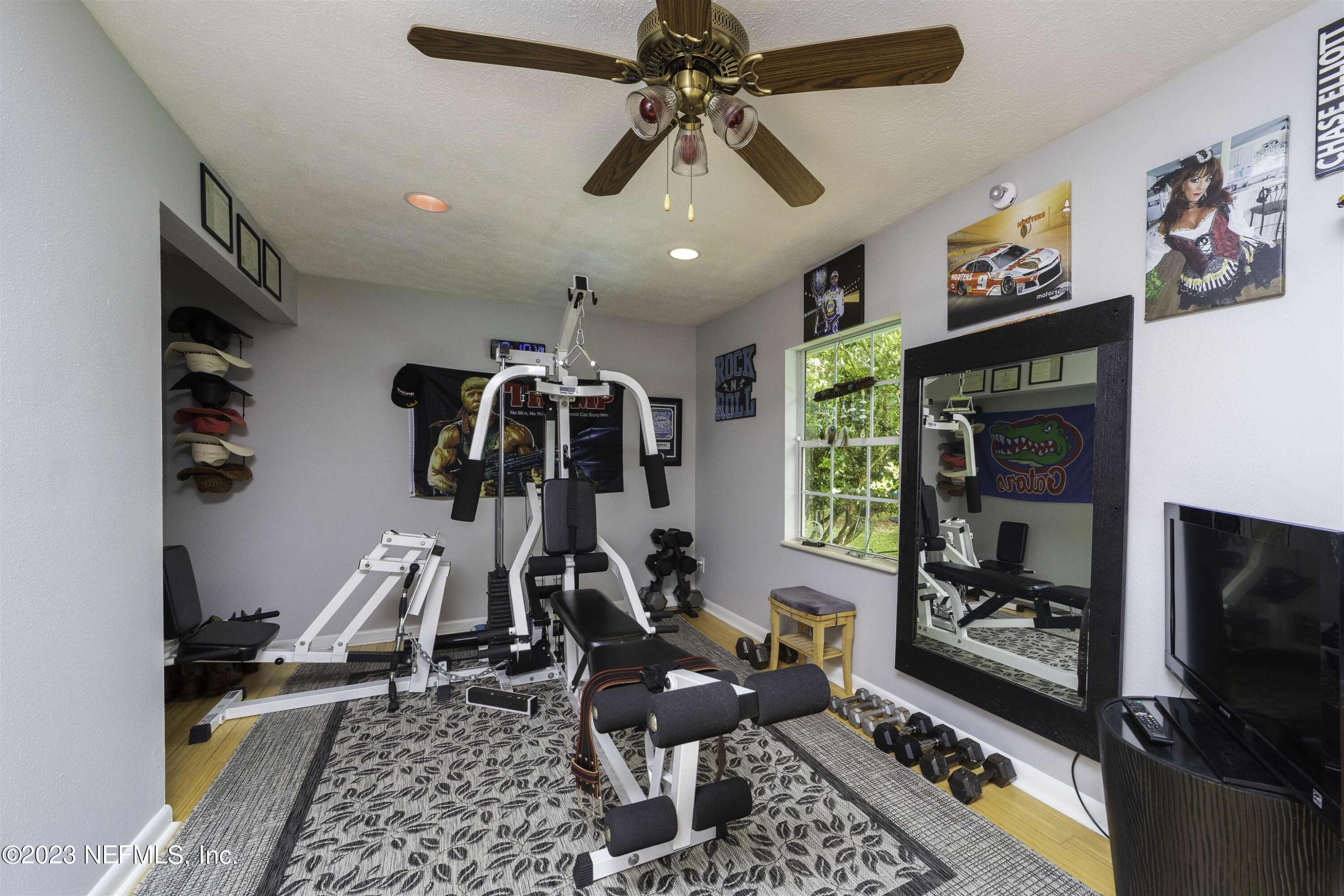 111 Loyola Road St. Augustine, FL 32086 - Photo 39 of 67 a room with gym equipment and a flat screen tv