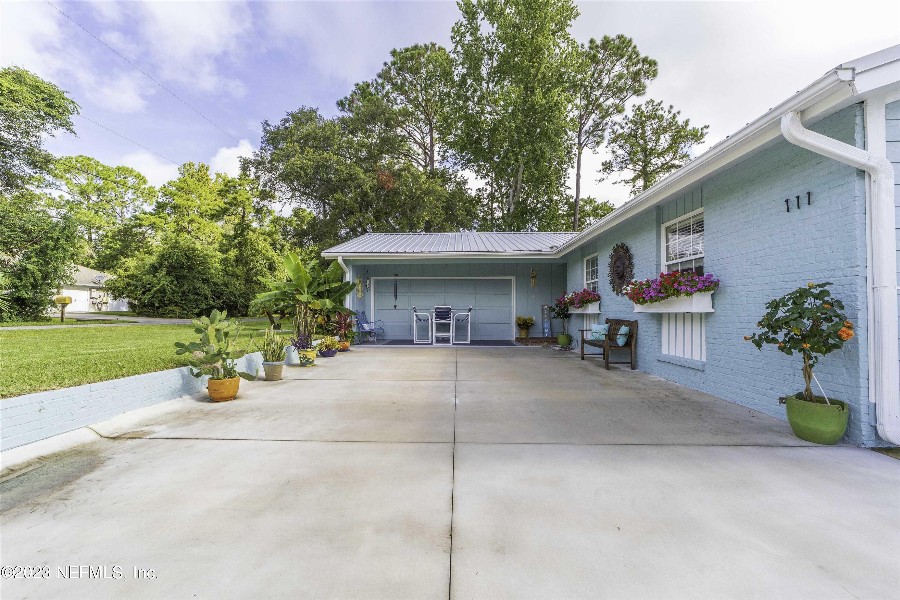 111 Loyola Road St. Augustine, FL 32086 - Photo 4 of 67 a view of a house with patio and a garden