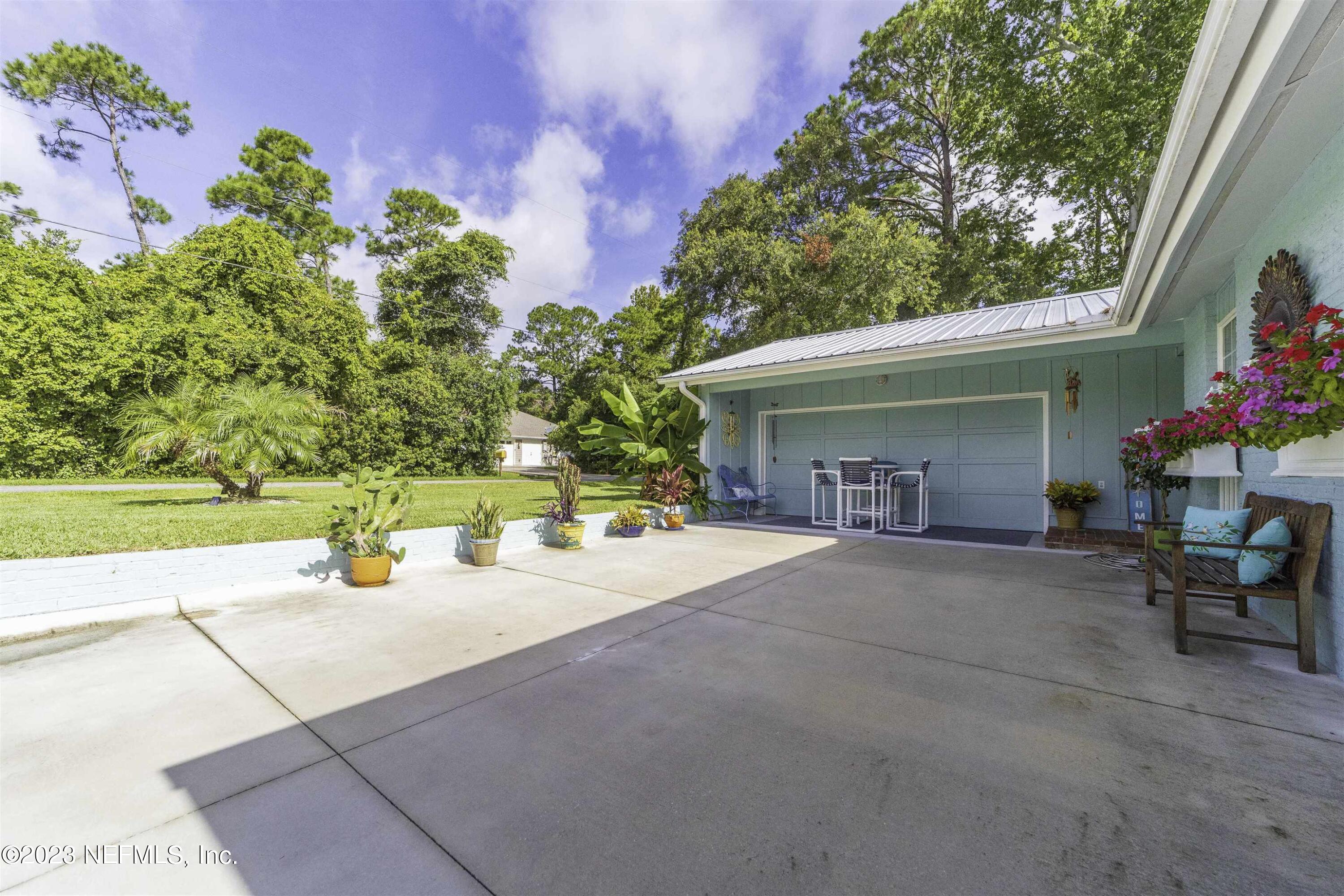 111 Loyola Road St. Augustine, FL 32086 - Photo 5 of 67 a view of a house with sitting area and garden