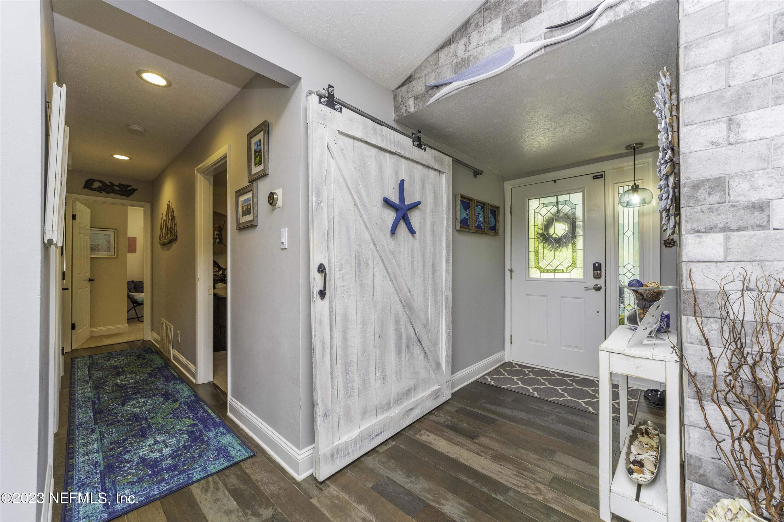 111 Loyola Road St. Augustine, FL 32086 - Photo 6 of 67 a view of an entryway with wooden floor and a livingroom view