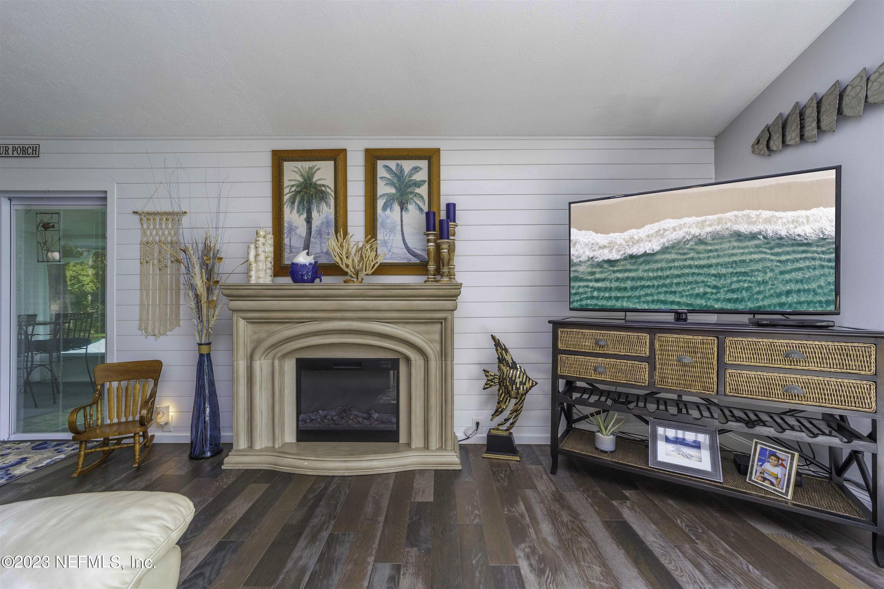 111 Loyola Road St. Augustine, FL 32086 - Photo 9 of 67 a living room with furniture a fireplace and a flat screen tv