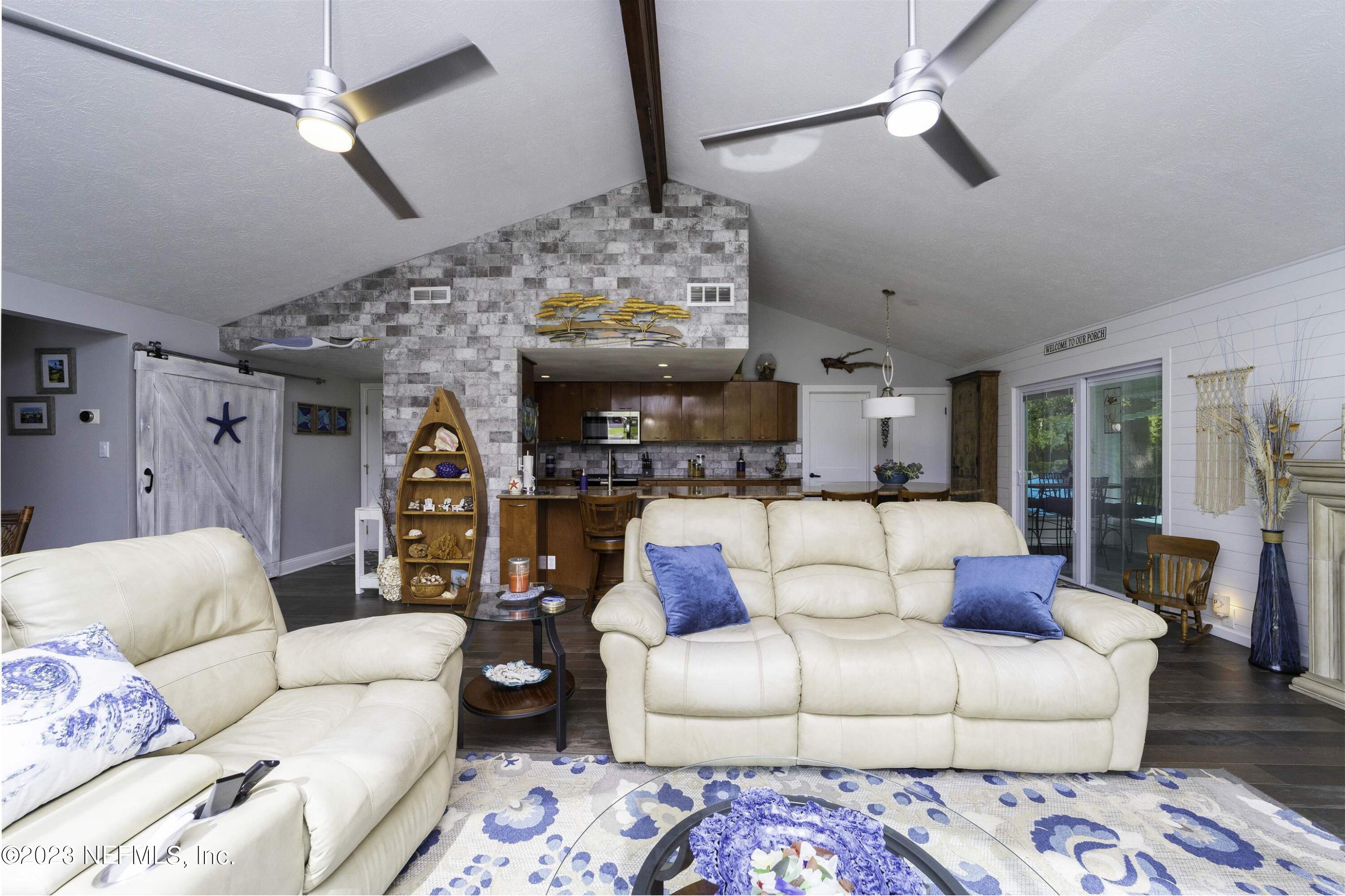 111 Loyola Road St. Augustine, FL 32086 - Photo 10 of 67 a living room with furniture and a chandelier