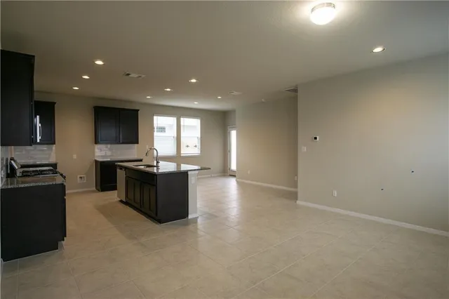 a living room with hard wood flooring and furniture