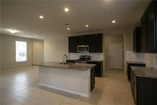 a kitchen with a sink and cabinets