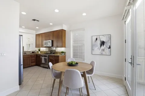 a view of a dining room with furniture and a kitchen