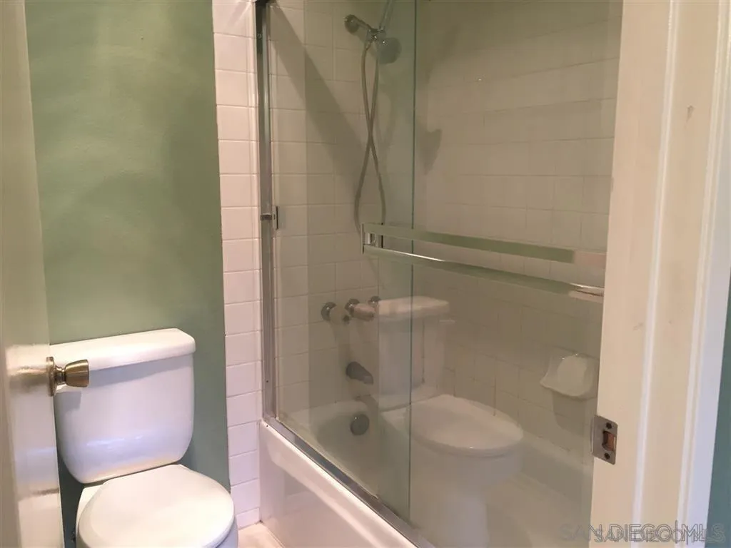 13294 Wimberly Square, Unit 228 San Diego, CA 92128 - Photo 20 of 24 a white toilet sitting next to a bath tub