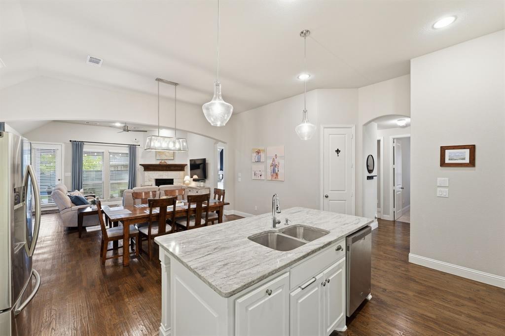 5105 Ember Place Little Elm, TX 76227 - Photo 11 of 35 a kitchen with a table chairs sink and wooden floor