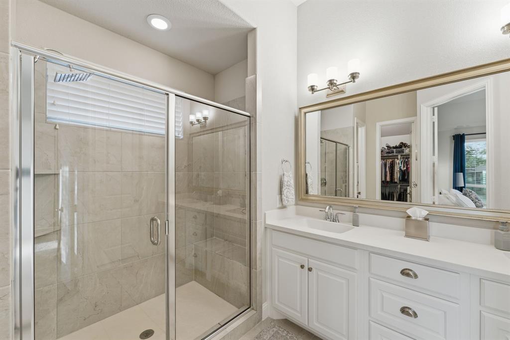 5105 Ember Place Little Elm, TX 76227 - Photo 17 of 35 a bathroom with a shower sink and mirror