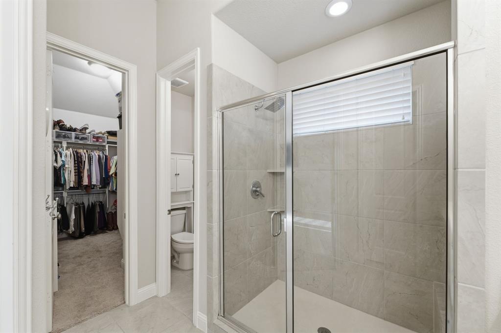 5105 Ember Place Little Elm, TX 76227 - Photo 19 of 35 a bathroom with a shower and a glass door