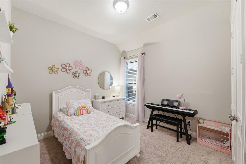 5105 Ember Place Little Elm, TX 76227 - Photo 21 of 35 a bedroom with a bed and a table