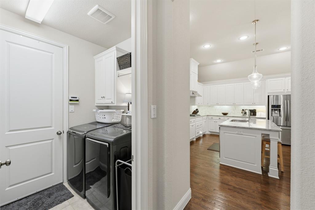5105 Ember Place Little Elm, TX 76227 - Photo 25 of 35 a kitchen with kitchen island a sink stainless steel appliances and cabinets