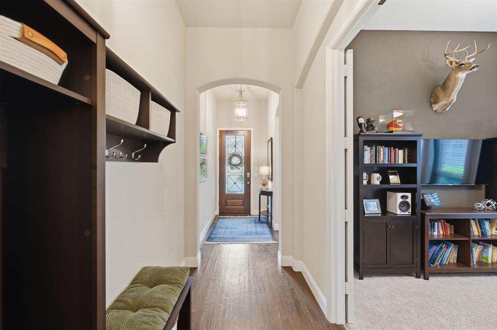 5105 Ember Place Little Elm, TX 76227 - Photo 5 of 35 a view of a hallway with wooden floor and dining room view