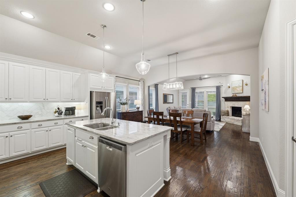 5105 Ember Place Little Elm, TX 76227 - Photo 7 of 35 a open kitchen with sink cabinets and wooden floor