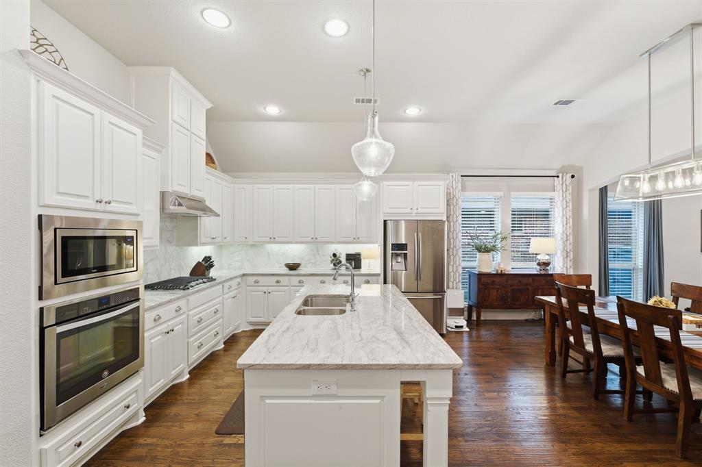 5105 Ember Place Little Elm, TX 76227 - Photo 9 of 35 a large kitchen with kitchen island a large island in the center