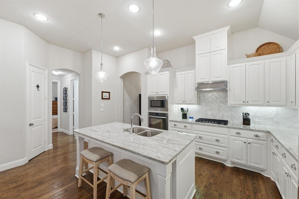 5105 Ember Place Little Elm, TX 76227 - Photo 10 of 35 a kitchen with white cabinets and refrigerator