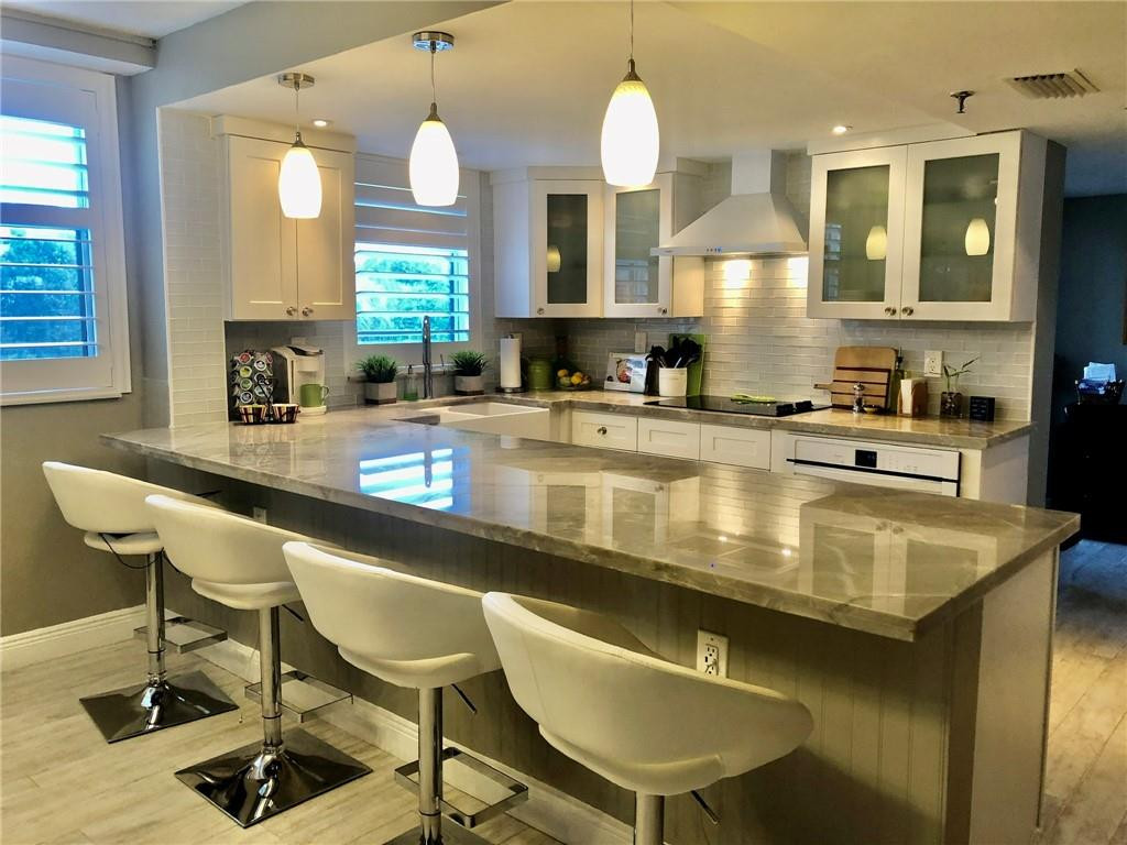 6463 La Costa Drive, Unit 305 Boca Raton, FL 33433 - Photo 1 of 20 a kitchen with a table chairs and living room