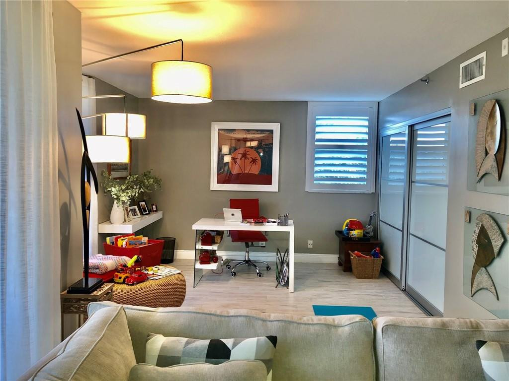 6463 La Costa Drive, Unit 305 Boca Raton, FL 33433 - Photo 11 of 20 a living room with furniture a window and a chandelier