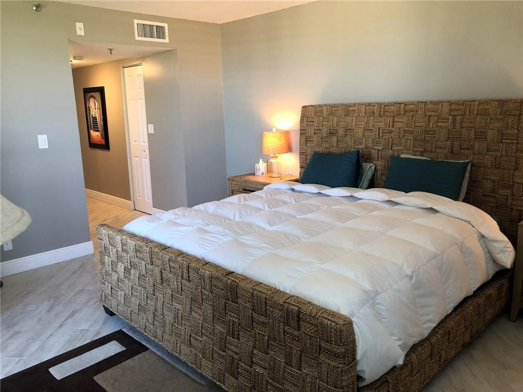 6463 La Costa Drive, Unit 305 Boca Raton, FL 33433 - Photo 14 of 20 a bedroom with a bed and a fireplace