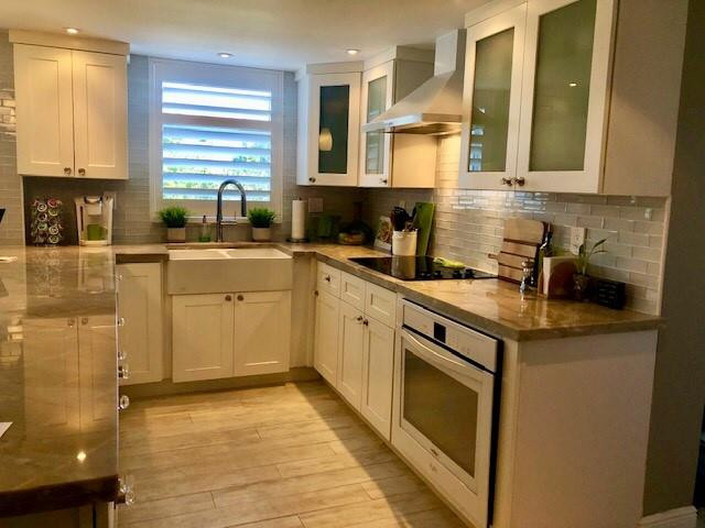 6463 La Costa Drive, Unit 305 Boca Raton, FL 33433 - Photo 2 of 20 a kitchen with a sink stove and cabinets