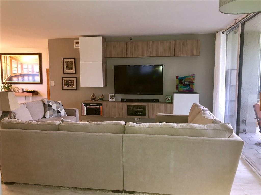 6463 La Costa Drive, Unit 305 Boca Raton, FL 33433 - Photo 10 of 20 a living room with furniture and a flat screen tv