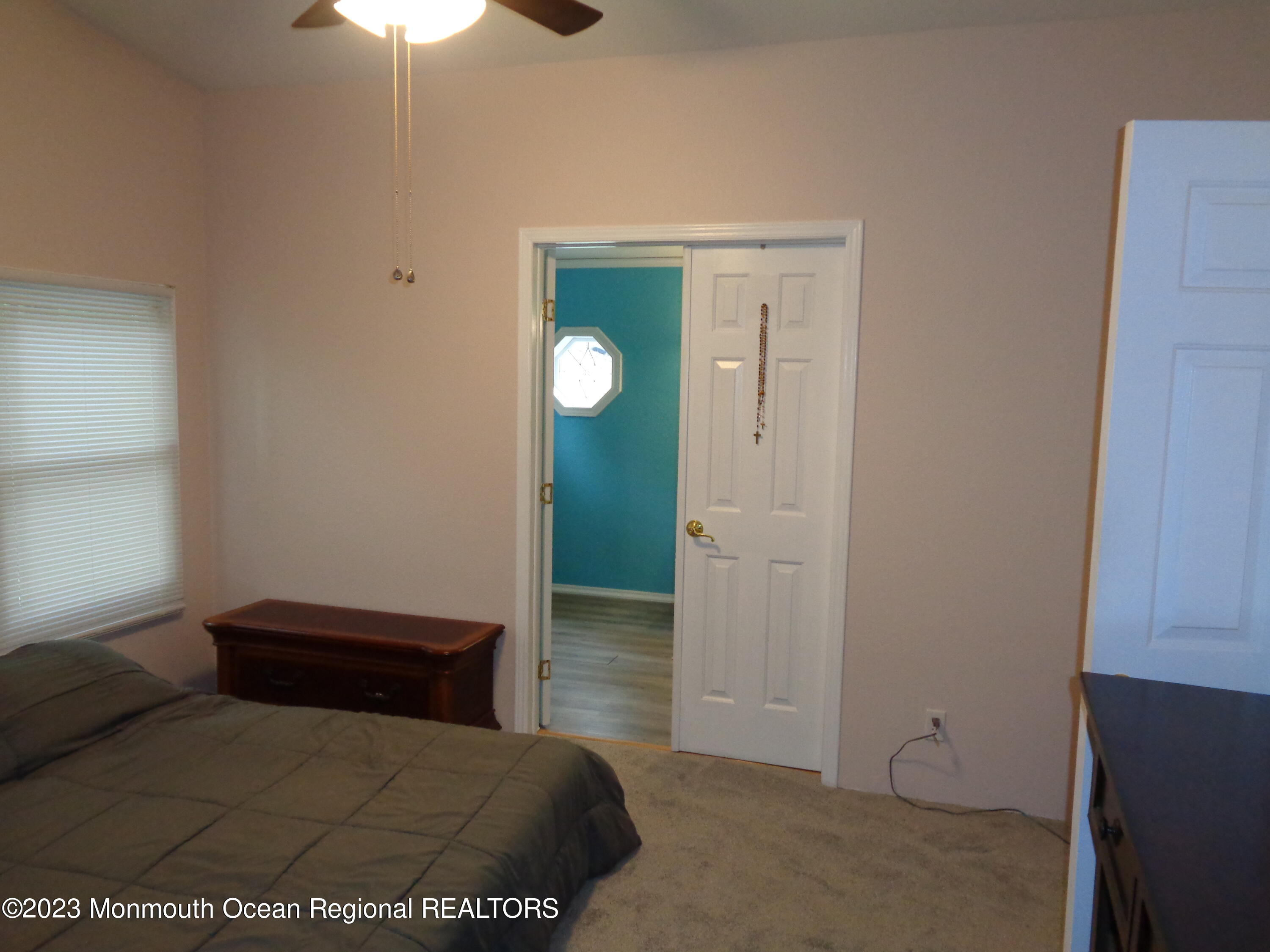 12 Pine Ridge Boulevard Whiting, NJ 08759 - Photo 16 of 23 a bedroom with a bed and a chandelier