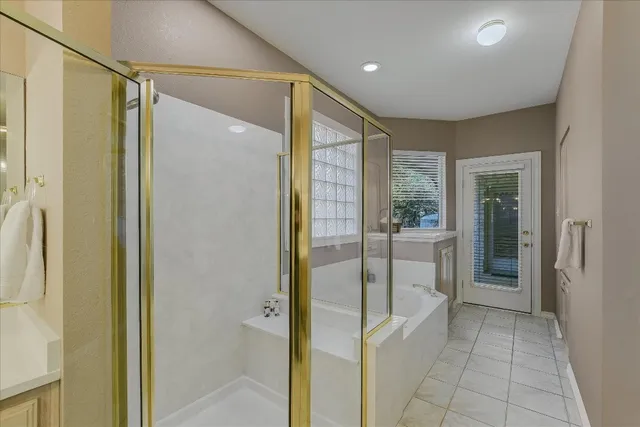 a bathroom with a glass shower door and a sink
