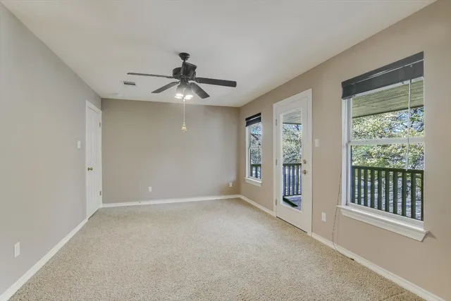 a view of a livingroom with a ceiling fan and window