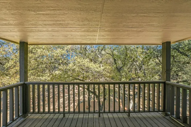 a wooden deck with a yard