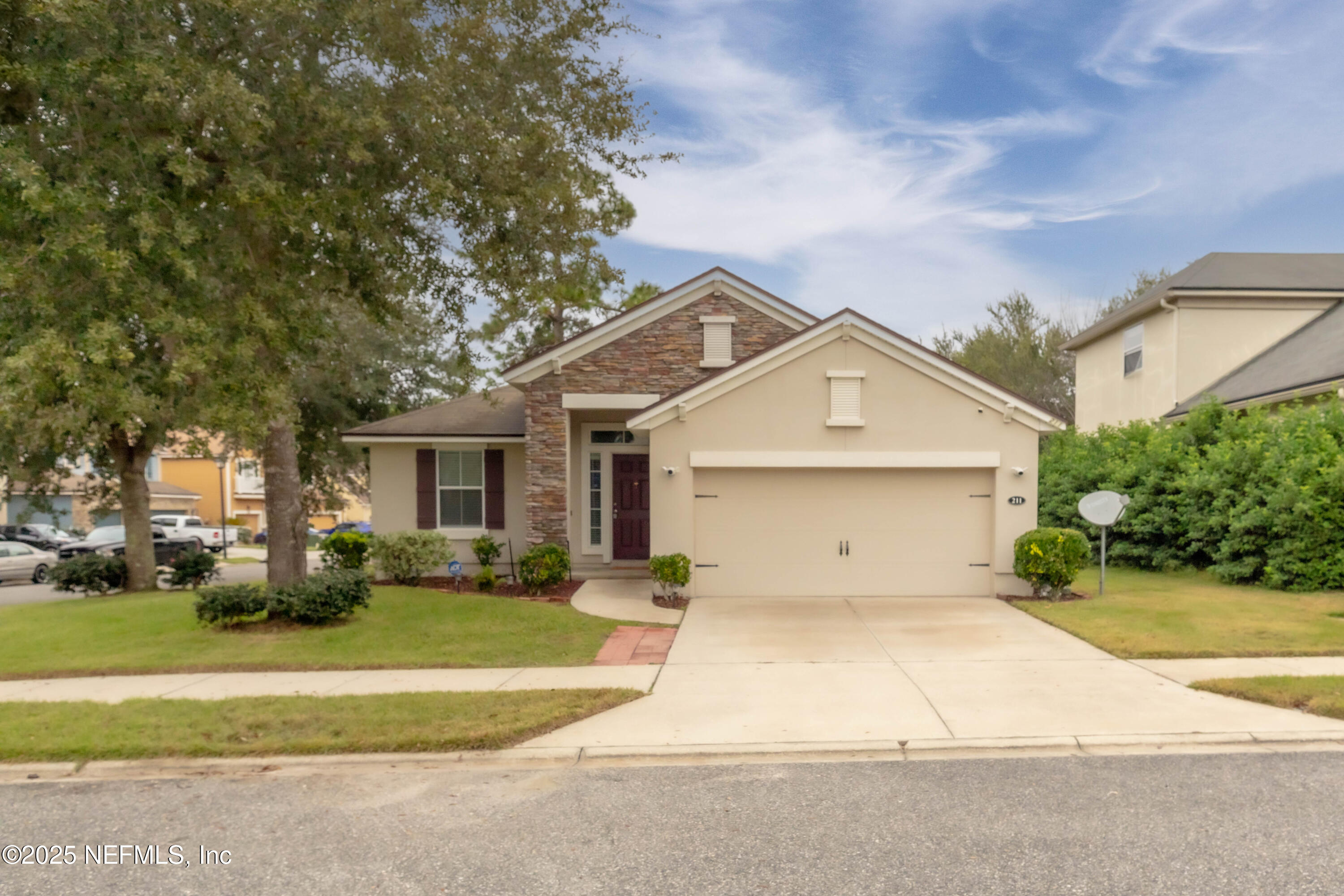 211 Amber Ridge Road Jacksonville, FL 32218 - Photo 1 of 39 a front view of a house with a yard and garage