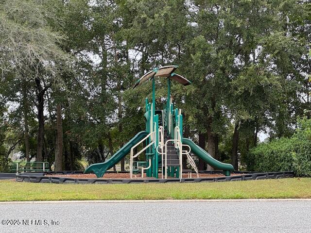 211 Amber Ridge Road Jacksonville, FL 32218 - Photo 31 of 39 a view of a house in a yard with potted plants and large trees