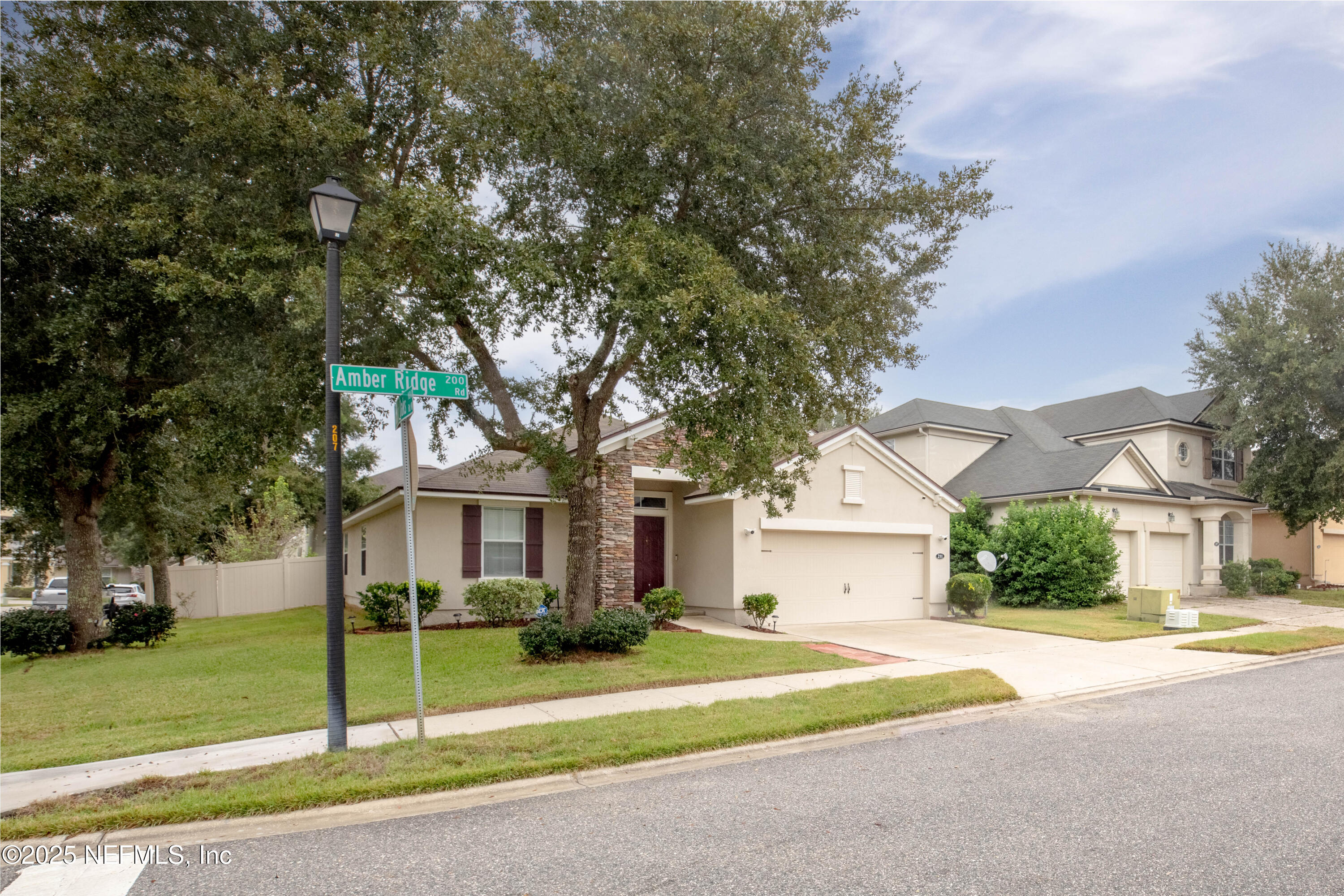 211 Amber Ridge Road Jacksonville, FL 32218 - Photo 4 of 39 a house that has a tree in front of it