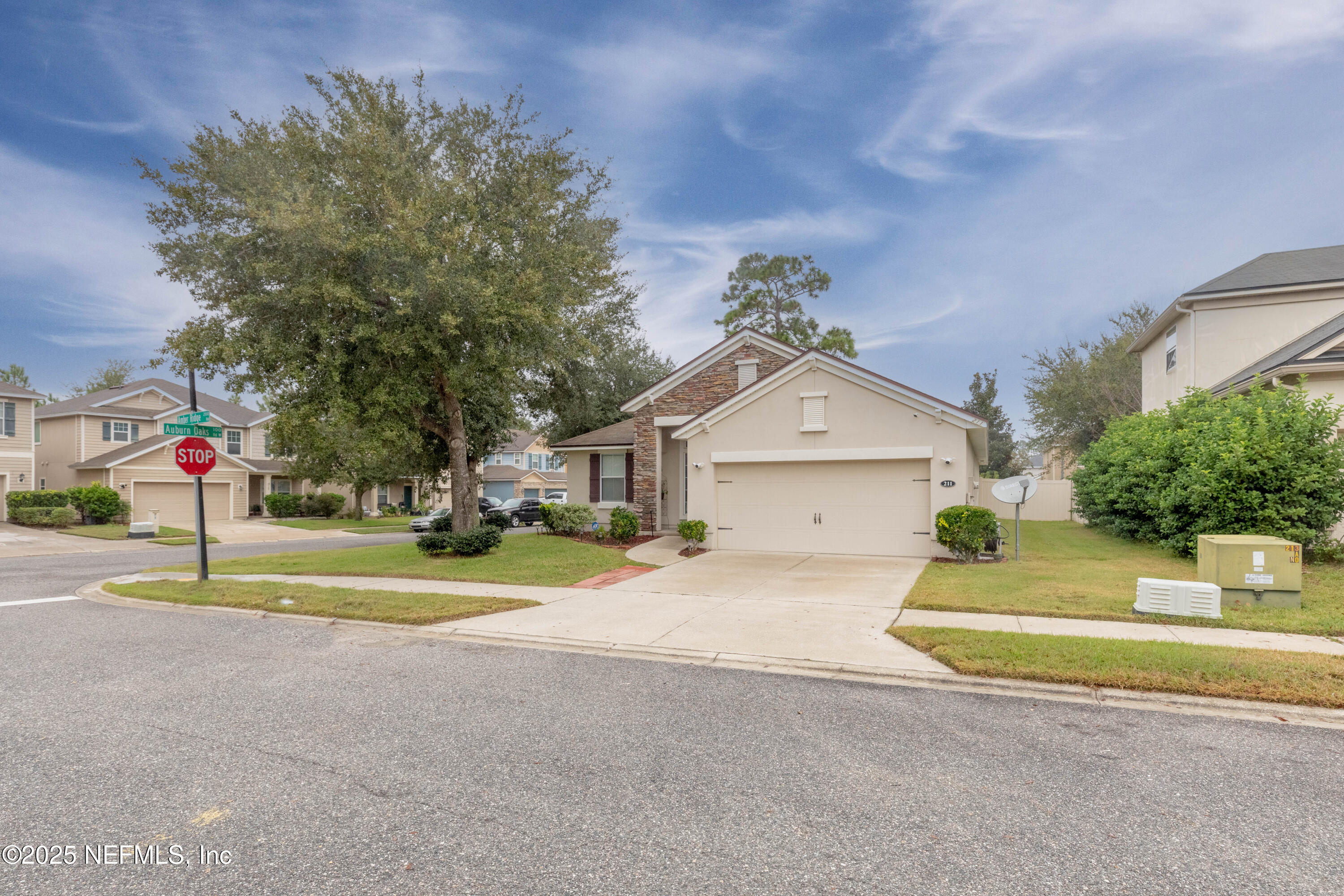 211 Amber Ridge Road Jacksonville, FL 32218 - Photo 5 of 39 a view of a house with a yard and large trees