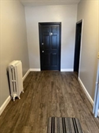 175 Hancock Street Everett, MA 02149 - Photo 14 of 15 a view of room with window and wooden floor