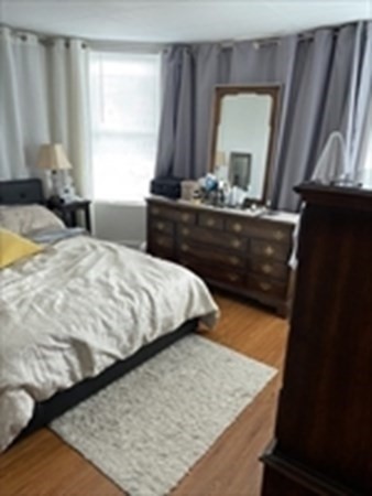 175 Hancock Street Everett, MA 02149 - Photo 15 of 15 a bed sitting in a bedroom next to a window