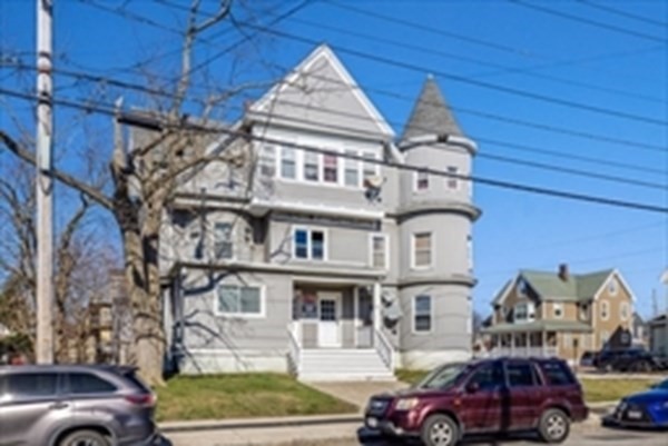 175 Hancock Street Everett, MA 02149 - Photo 3 of 15 a front view of a building with cars parked
