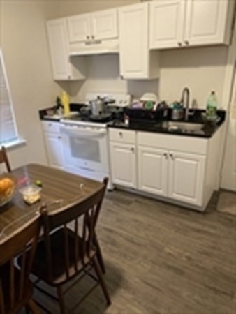 175 Hancock Street Everett, MA 02149 - Photo 6 of 15 a kitchen with stainless steel appliances a stove a sink and white cabinets