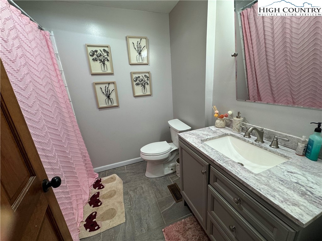 2047 Cline Road Rural Retreat, VA 24368 - Photo 16 of 35 a bathroom with a granite countertop sink and a mirror