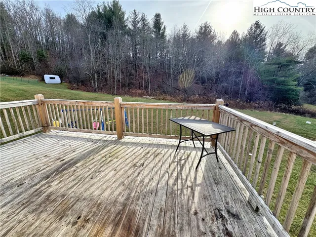 a view of backyard with deck and trees