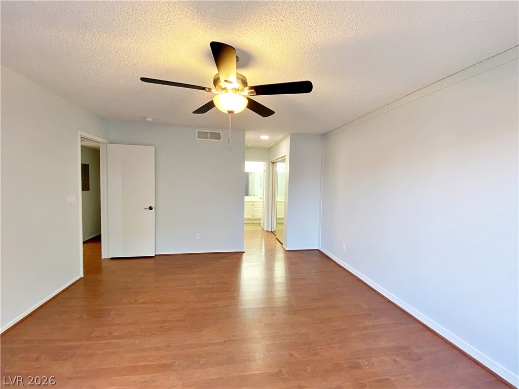 1575 West Warm Springs Road, Unit 1024 Henderson, NV 89014 - Photo 16 of 25 Rich hardwood-style flooring and a ceiling fan enhance this adaptable private space.