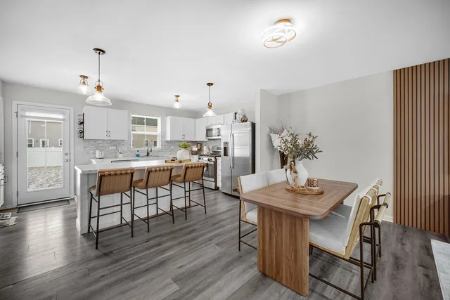 a view of a dining room with furniture and wooden floor